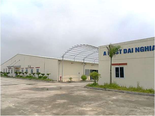 A First Dai Nghia sign on the factory exterior and courtyard