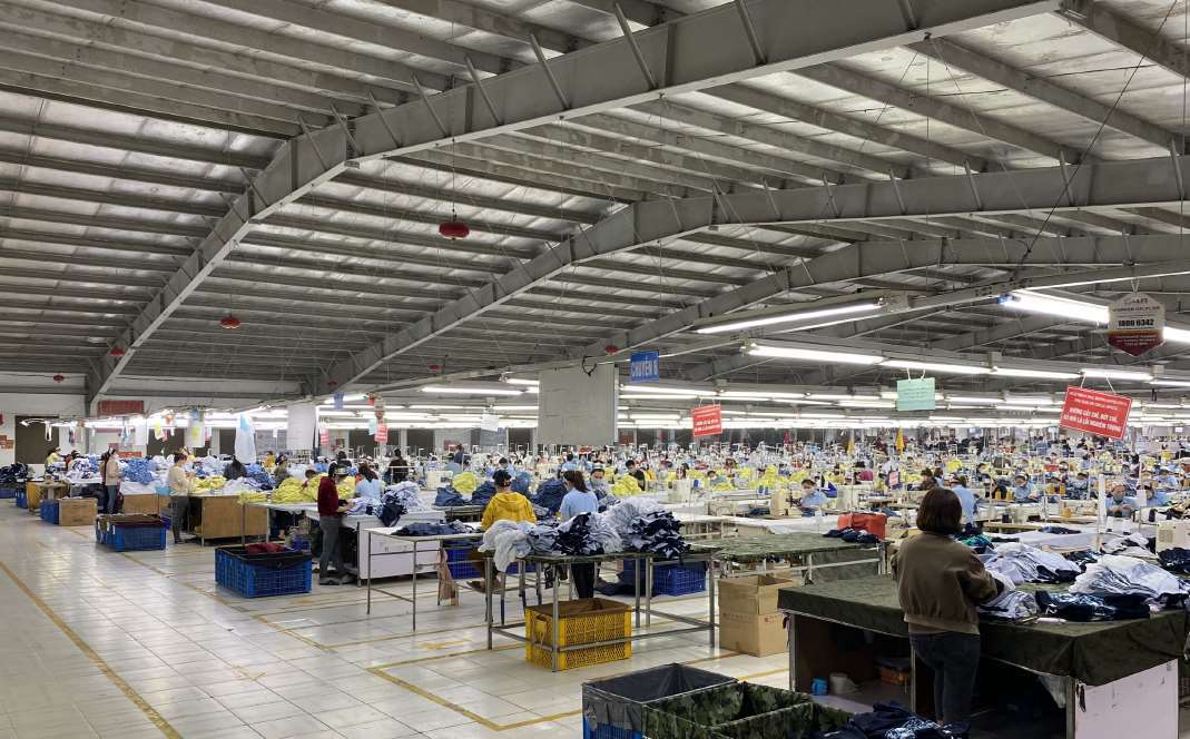 Wide view of the garment production floor at the Hanoi factory