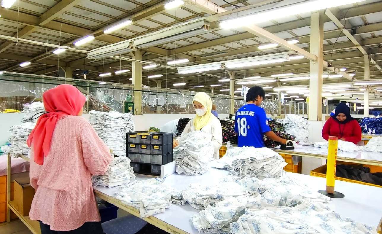 Team members finishing and pressing garments at the Sukabumi factory